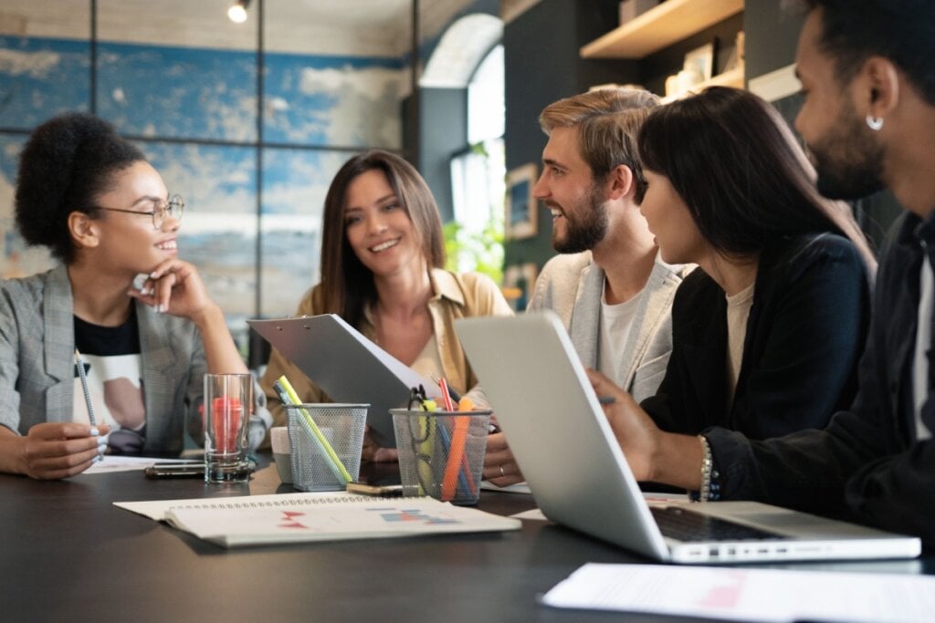 Equipe trabalhando com computadores em sala corporativa