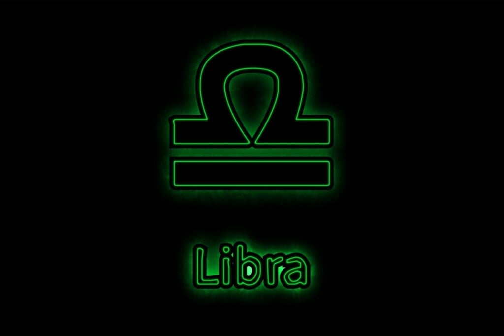 símbolo e nome do signo de libra verde em fundo preto