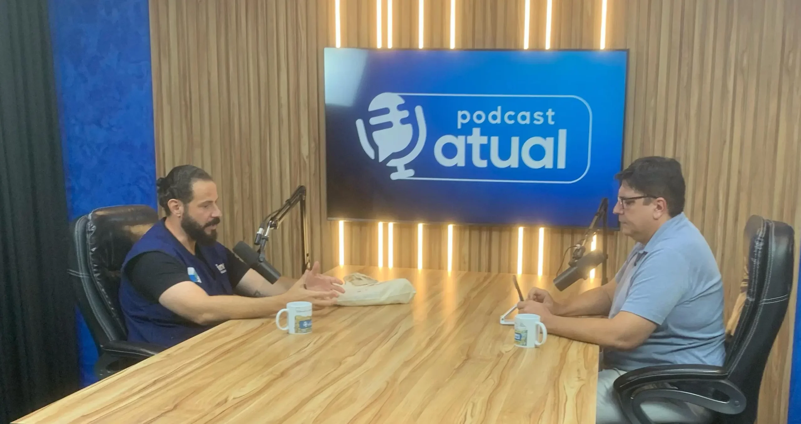 Entrevistado e entrevistador sentados à mesa