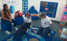 Profissional do Grupamento de Ações com Cães da Guarda Municipal de Mangaratiba orienta uma aluna durante atividade