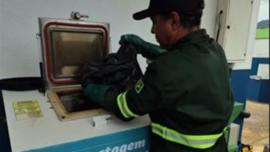 Funcionário realiza o descarte de resíduos orgânicos na máquina de compostagem