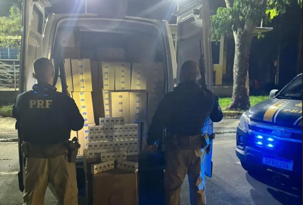 Policiais rodoviários federais escoltam um furgão com cerca de 40 mil maços e nota fiscal com indícios de falsificação