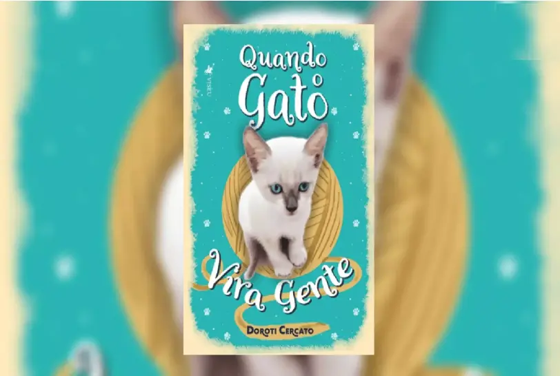 Capa do livro “Quando o Gato Vira Gente”, de Doroti Cercato, com fundo em tom turquesa e ilustração central de um gato branco de olhos azuis, posicionado dentro de uma moldura oval dourada. O título aparece em destaque na parte superior e inferior da imagem, em tipografia estilizada.